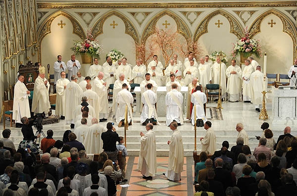 Area clergy bless newly ordained priests Father Luke Uebler, Father Cole Webster, Father Robert Agbo and Father Martin Gallagher on the altar during the Ordination Mass at St. Joseph Cathedral. (Dan Cappellazzo/Staff Photographer)